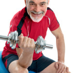 Senior man working with weights in gym